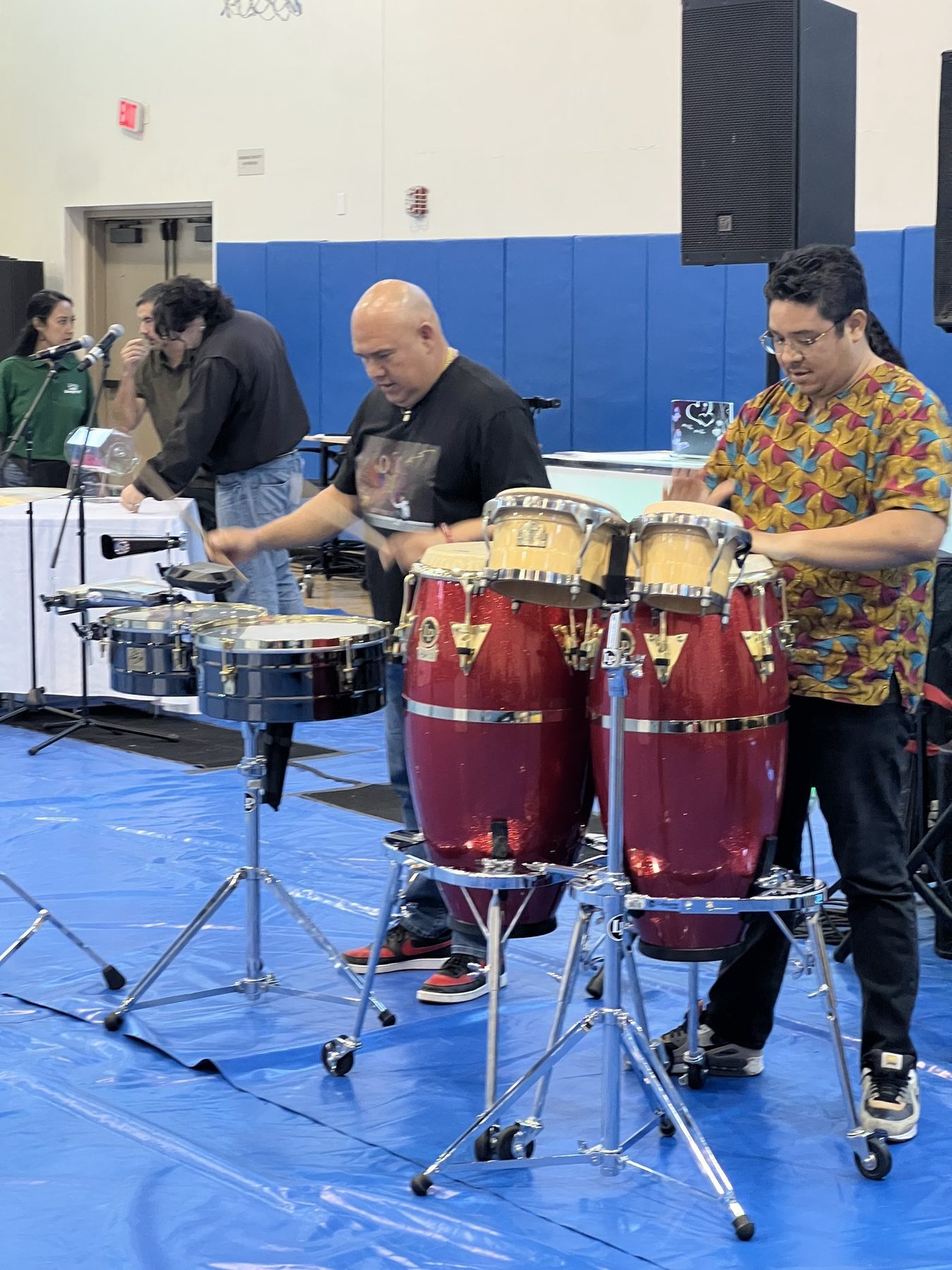 Mentors playing congas and timbales at the showcase